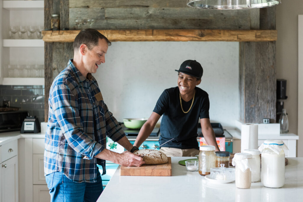 Dr. Aaron Hartman in the kitchen with his son.